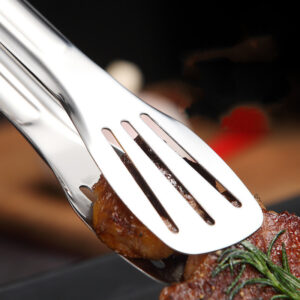 Metallzange greift saftiges Steak auf Teller